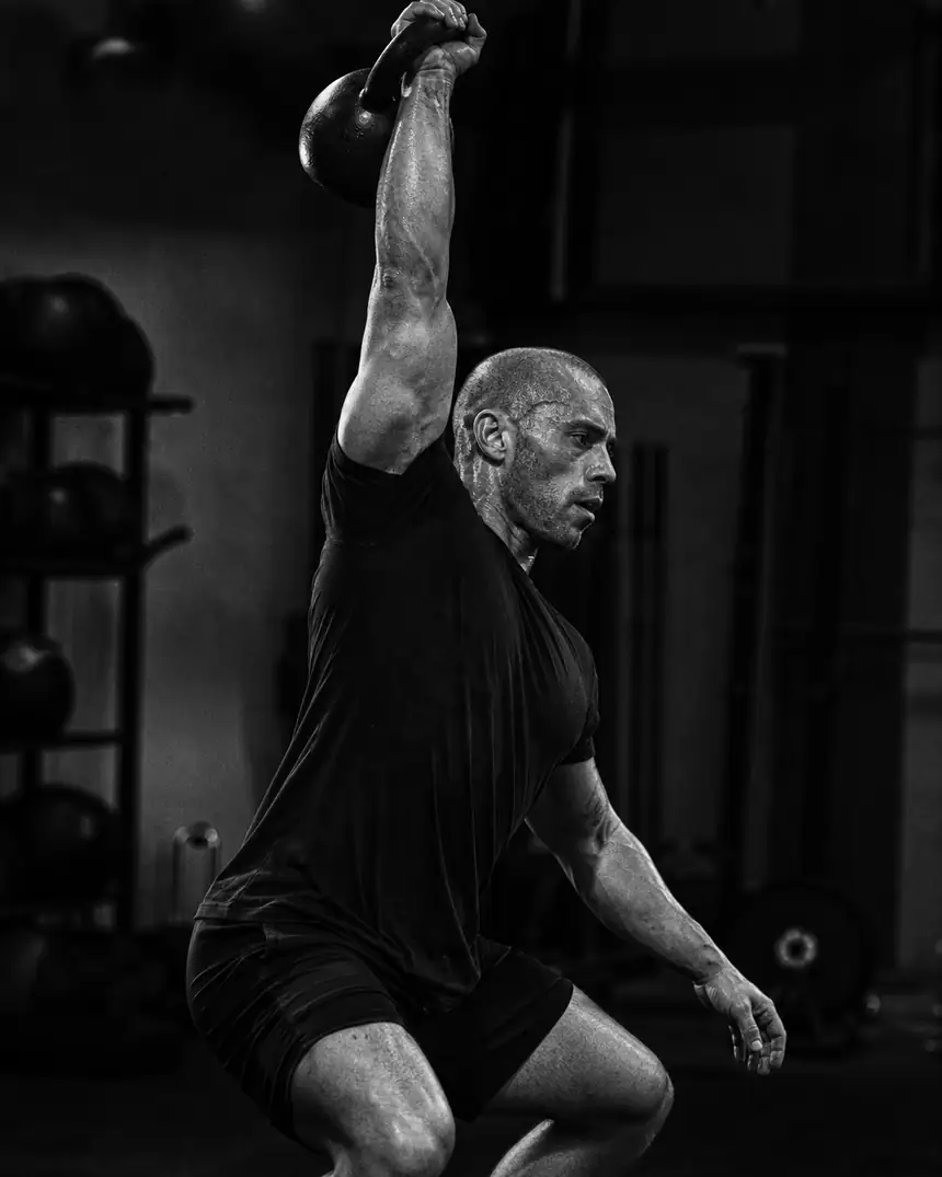 Athlete training with kettlebells