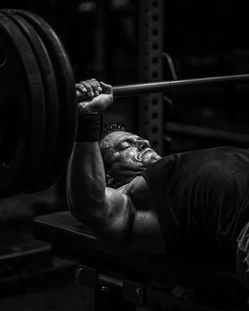 Athlete bench pressing heavy barbell